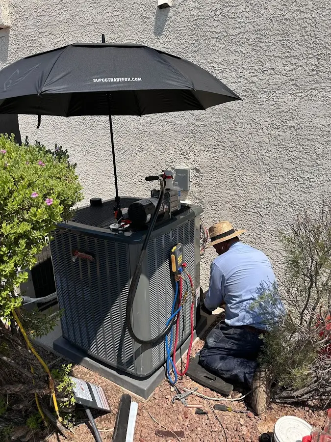 HVAC technician performing outdoor AC maintenance in West Norriton